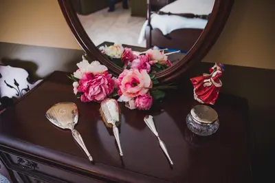a table with a mirror and a bouquet of flowers at Misty Meadows B and B in Langford