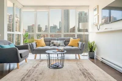 a living room with a couch and a table at Sunset Beach Walk 2BD+2BA+1PRK Yaletown in Vancouver