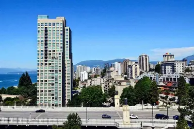 a city skyline with a tall building and a parking lot at Sunset Beach Walk 2BD+2BA+1PRK Yaletown in Vancouver
