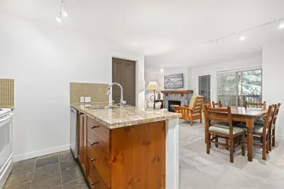 a kitchen and dining room with a sink and a table at Lost Lake Lodge by Whistler Premier in Whistler