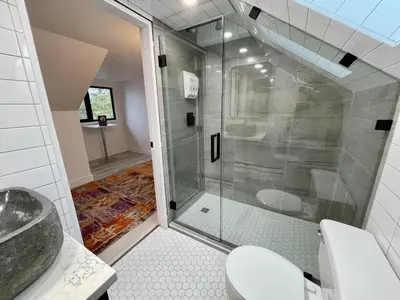 a bathroom with a shower and a toilet at Salt Loft - Oceanfront, Hot Tub And Firepit! in Ucluelet