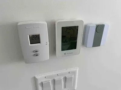 a clock on a wall next to an electrical outlet at Royal Blue Wild Oasis Corner PNHSE KingBed U/G Wi-fi in Edmonton