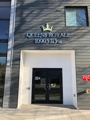 a queens royale building with a sign above a door at Hot Arabaian NightsCornerPNHSEkingWifiU/G in Edmonton