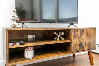 a wooden entertainment center with a tv on top at Hot Arabaian NightsCornerPNHSEkingWifiU/G in Edmonton