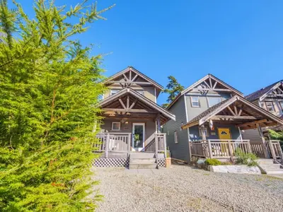 a large house with a gambrel roof at The Perch Modern 2 Bed Cabin with Patio and Hot Tub in Ucluelet