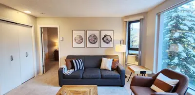 a living room with a couch and two chairs at 1BR in Marquise, Dog Friendly, Close to Ski Hill, Pool, Sauna, Hot Tub, Fitness Suite, AC in Whistler