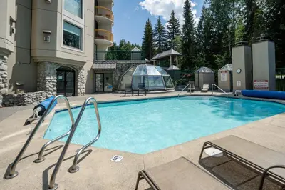 a large swimming pool in a resort building at 1BR in Marquise, Dog Friendly, Close to Ski Hill, Pool, Sauna, Hot Tub, Fitness Suite, AC in Whistler