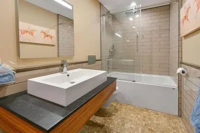 a bathroom with a white sink and a bath tub at Salishan Chief Suite by EMR Vacation Rentals in Cowichan Bay