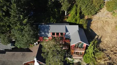 an aerial view of a house with a roof at Salishan Chief Suite by EMR Vacation Rentals in Cowichan Bay