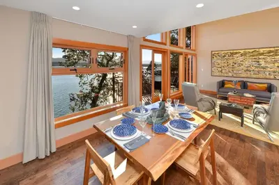 a dining room with a table and some chairs at Salishan Tree House Suite by EMR Vacation Rentals in Cowichan Bay