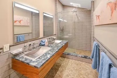 a bathroom with a sink and a mirror at Salishan Tree House Suite by EMR Vacation Rentals in Cowichan Bay
