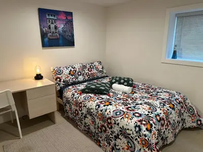 a bedroom with a bed with a desk and a bed sidx sidx sidx at Private room in a Shared house in Vancouver