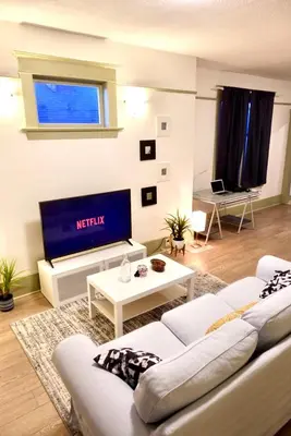 a living room with a couch and a tv at Private room in a Shared house in Vancouver