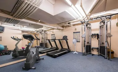a gym with treadmills and elliptical machines at 1BD+Den condo, with free parking in Downtown! in Vancouver