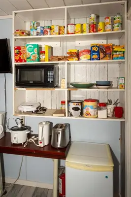a kitchen with a microwave and a table with food at Guest Suite - Private Retreat - J-1 in Abbotsford