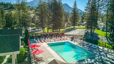 an overhead view of a pool with chairs and umbrellas at RidgeView Resort in Radium Hot Springs