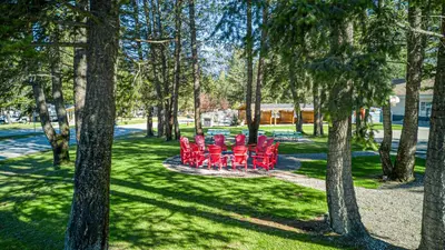 a group of red chairs sitting in a park at RidgeView Resort in Radium Hot Springs