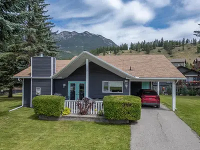 a house with a car parked in the driveway at RidgeView Resort in Radium Hot Springs