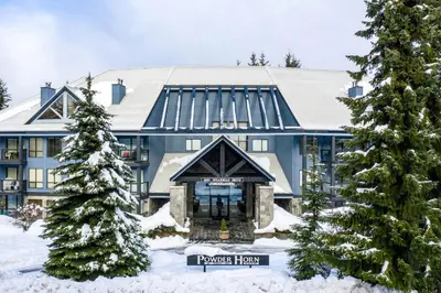 a large blue building with a sign in front of it at Powderhorn by Whistler Premier in Whistler