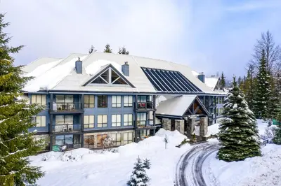 a large house with snow on the ground at Powderhorn by Whistler Premier in Whistler