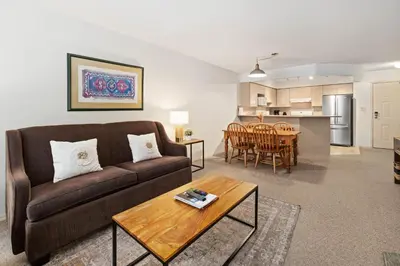 a living room with a couch and a table at Powderhorn by Whistler Premier in Whistler