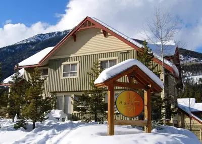 a basketball hoop in front of a house in the snow at Aurora Townhomes by StayIn in Panorama