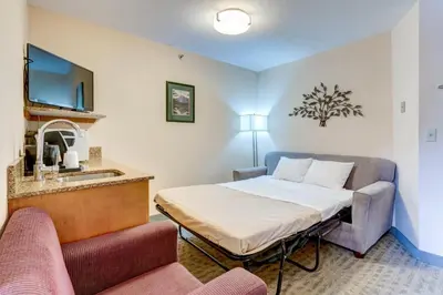 a hotel room with a bed and a sink at Chateau Canmore in Canmore