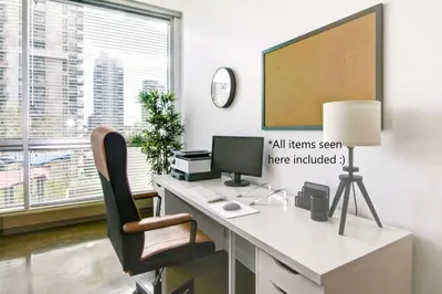 an office with a desk with a computer and a chair at Stylish 1BR, Stampede & Free Parking by Doorbed in Calgary