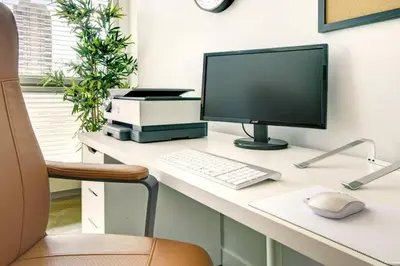 a desk with a computer monitor and a keyboard and mouse at Stylish 1BR, Stampede & Free Parking by Doorbed in Calgary