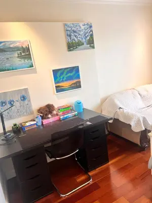 a desk with a cat sleeping on it in a bedroom at Lucky suite, two-bedroom suite with independent entrance in Richmond close to YVR in Richmond