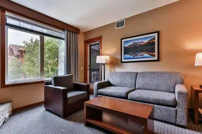 a living room with a couch and a chair at Luxury Falcon Crest Lodge 1 Bedroom 1 Pullout Kitchen Hot Tub in Canmore