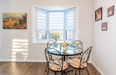 a dining room with a glass table and chairs at Southgate 5 Bedroom Vacation Home with Double Garage in Edmonton