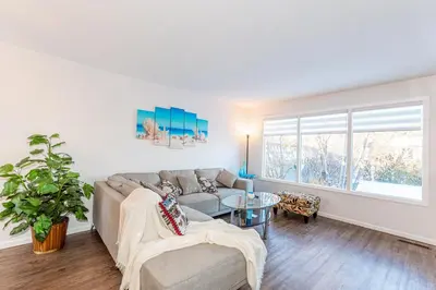 a living room with a couch and a table at Southgate 5 Bedroom Vacation Home with Double Garage in Edmonton