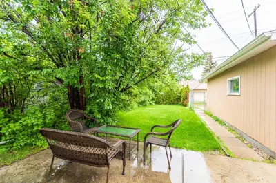 a group of chairs and a table in a yard at Southgate 5 Bedroom Vacation Home with Double Garage in Edmonton