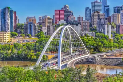a white bridge in front of a city at Southgate 5 Bedroom Vacation Home with Double Garage in Edmonton
