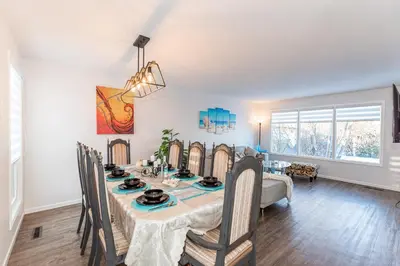 a dining room with a table and chairs at Southgate 5 Bedroom Vacation Home with Double Garage in Edmonton