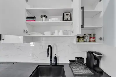 a kitchen with a sink and a counter top at You will love this 2BR Guest Suite in SE Calgary in Calgary
