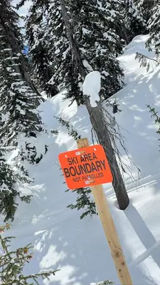 a sign in the snow next to some trees at Magical Views at Southpoint Big White! Best Location! in Big White