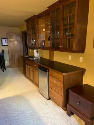 a kitchen with wooden cabinets and a dishwasher at Magical Views at Southpoint Big White! Best Location! in Big White