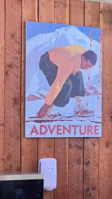 a poster of a man on skis on a wall at Magical Views at Southpoint Big White! Best Location! in Big White