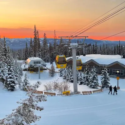 a ski resort with a ski lift in the snow at Magical Views at Southpoint Big White! Best Location! in Big White