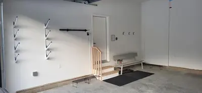a room with a staircase and a white wall at Fernie Escape - Mountain Home on the Ski Hill in Fernie