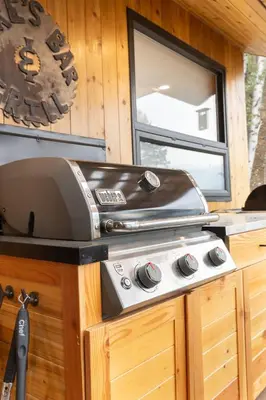 a grill sitting on top of a stove in a cabin at The Kootenay Lake House - A Private Luxury Retreat in Nakusp