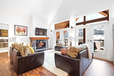a living room with two couches and a fireplace at Luxury Penthouse At Solar A Resort And Spa in Canmore