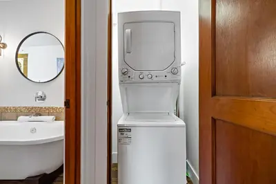 a bathroom with a toilet and a sink and a mirror at Luxury Penthouse At Solar A Resort And Spa in Canmore