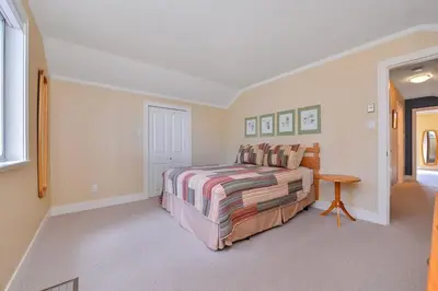 a bedroom with a bed and a table in it at Kye Bay Winter Beach House by EMR Vacation Rentals in Comox