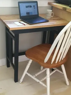 a desk with a laptop computer on top of it at Cozy ,artistic cottage in a garden setting close to the beach and hiking trails. in Powell River