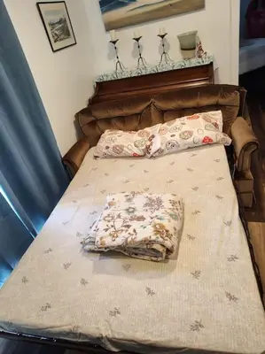 a bed with two pillows on top of it at Tranquil & Tasteful One Bdrm Private Suite NE in Edmonton