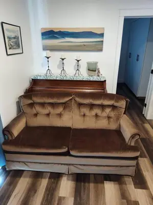 a brown leather couch sitting in a living room at Tranquil & Tasteful One Bdrm Private Suite NE in Edmonton