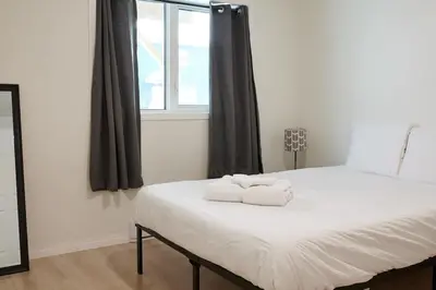 a bedroom with a bed with two towels on it at NN - The Névé - Crestview 1-bed 1-bath in Whitehorse